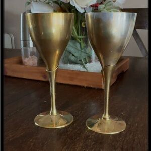 Elegant vintage brass wine goblets.
